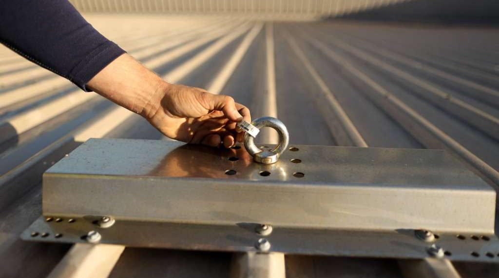 Technician conducting safety inspecting - roof anchor